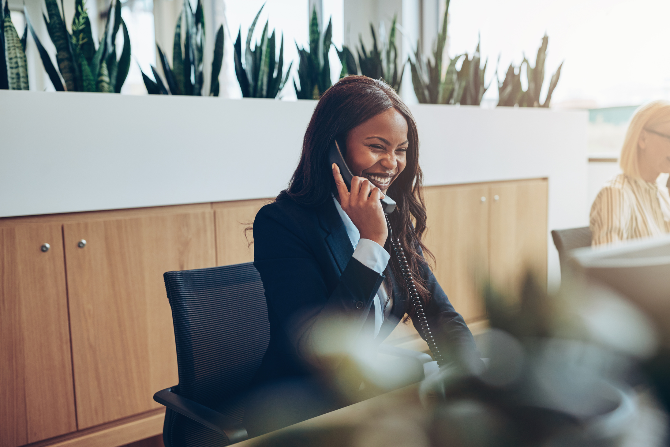 African American Businesswomen Talking on an Office Telephone